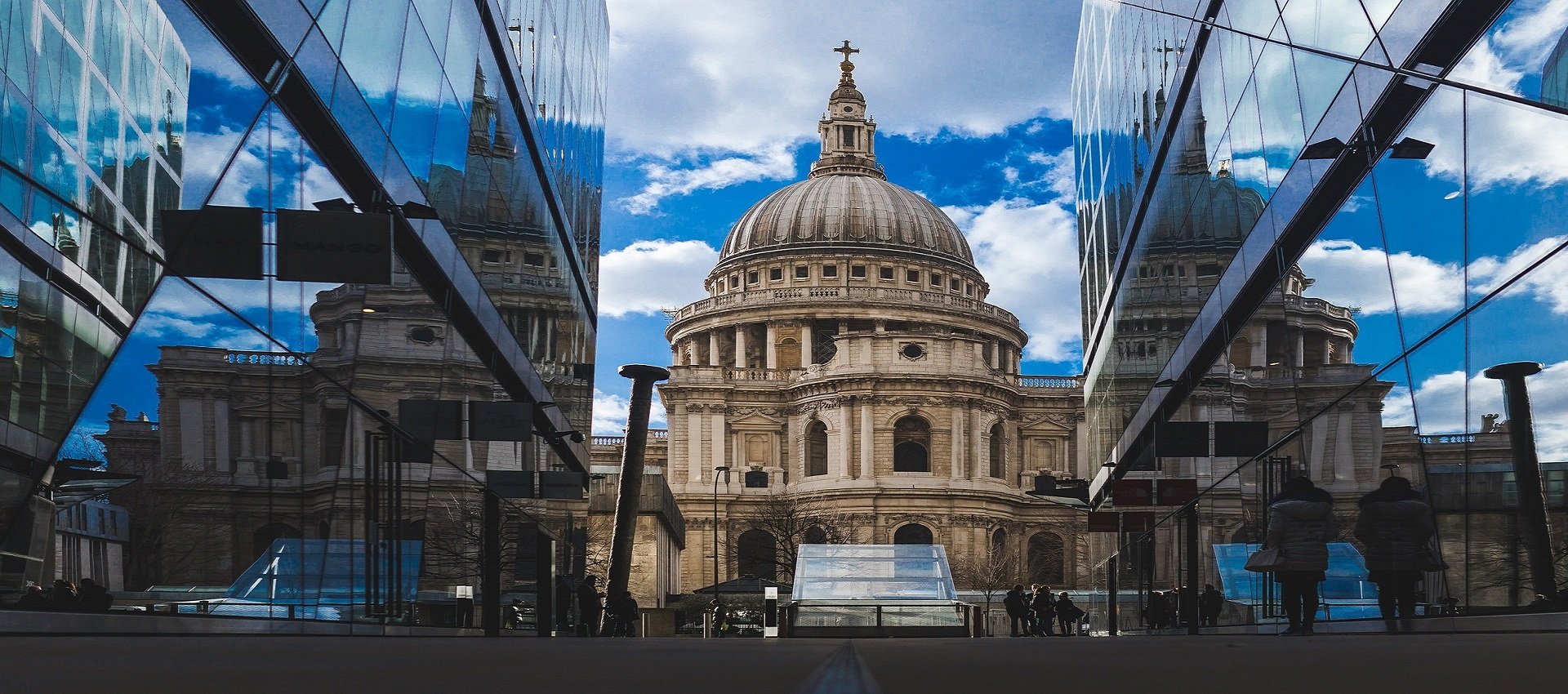St Paul's Cathedral as seen between two glass sky rise buildings in the financial district of London.