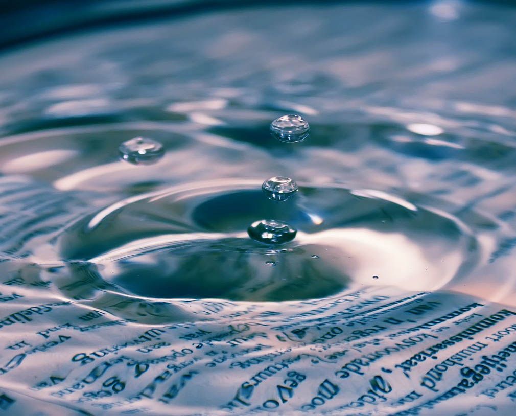 This image features a water droplet with a background images featuring the Financial Times