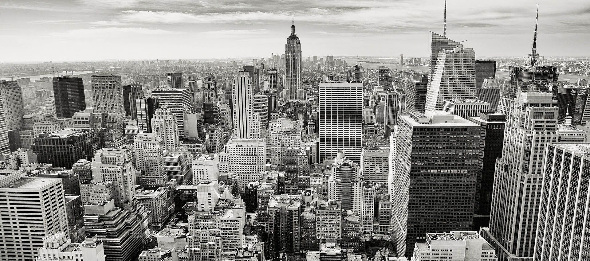 A photo of Manhattan, New York, in black and white taken from a building in the financial district.